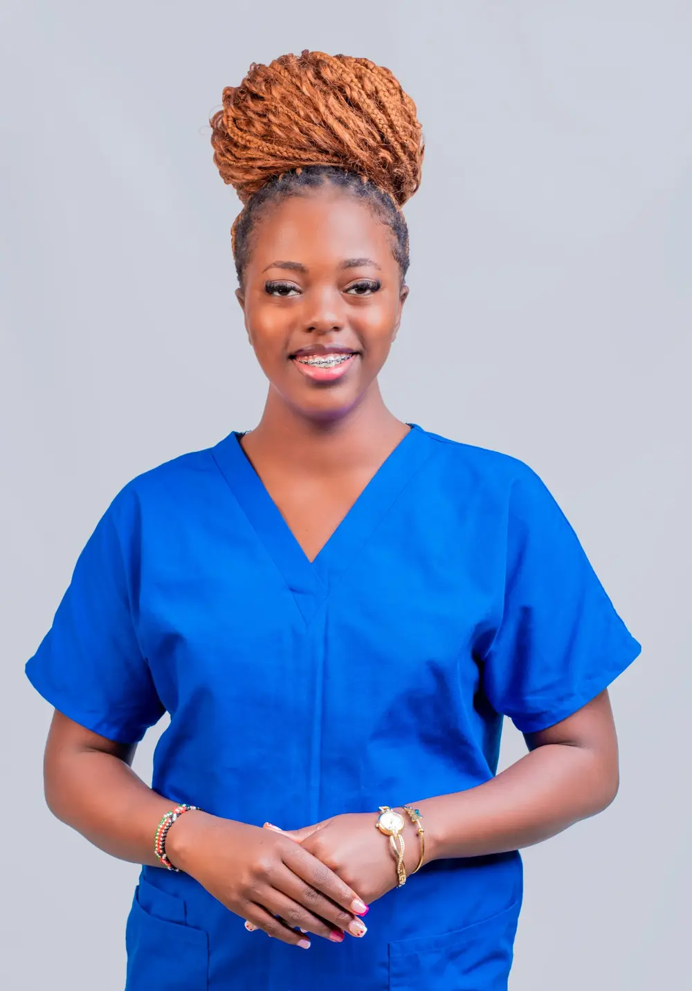 Cerine C., CEO of Serene Home Care Services, wearing blue clinical scrubs